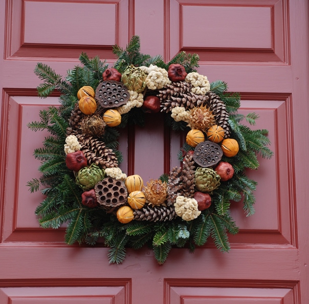This residential wreath incorporates the seed heads from pond lilies as well as pine cones.